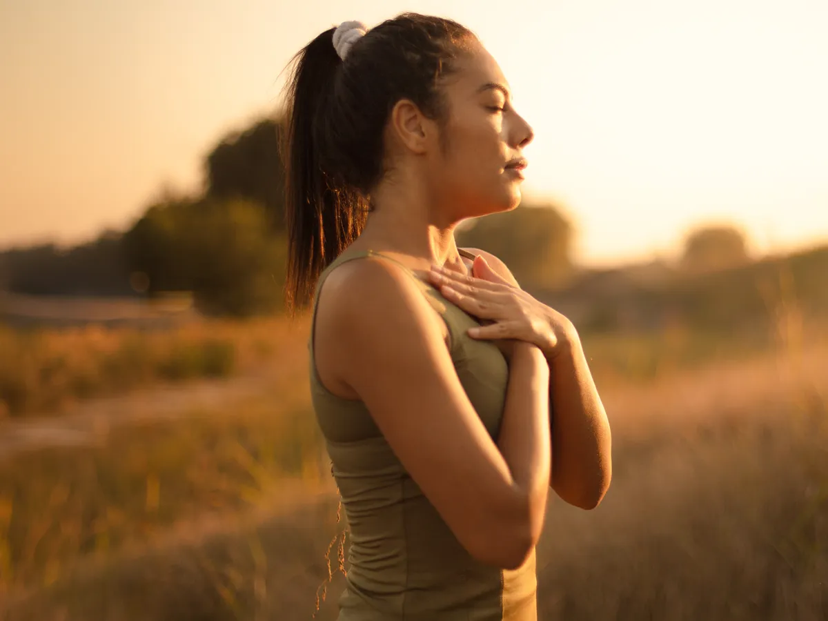 Woman practicing mindful breathing outdoors