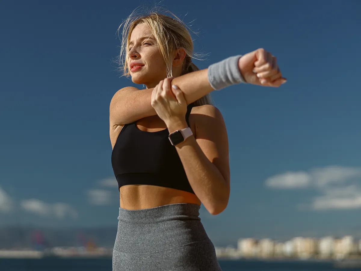 Athletic woman stretching outdoors